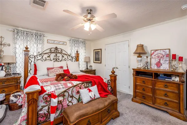 a bedroom with a bed and a dresser in it
