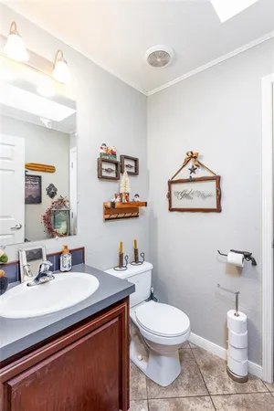 a bathroom with a toilet a sink and a mirror