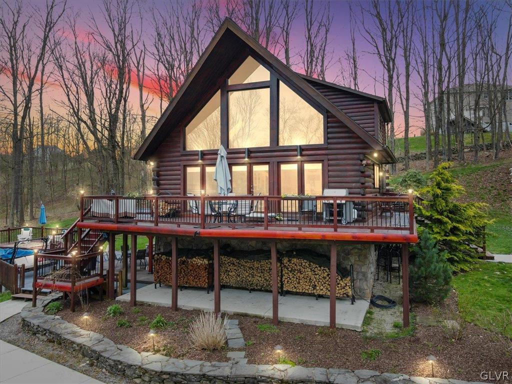 a view of a house with backyard and sitting area