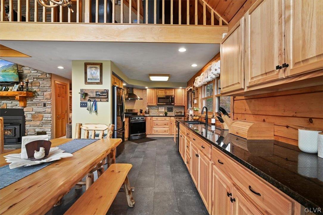 461 T Rte 318 Moscow, PA 18444 - Photo 13 of 50 a kitchen with stainless steel appliances kitchen island granite countertop lots of counter top space and wooden floor