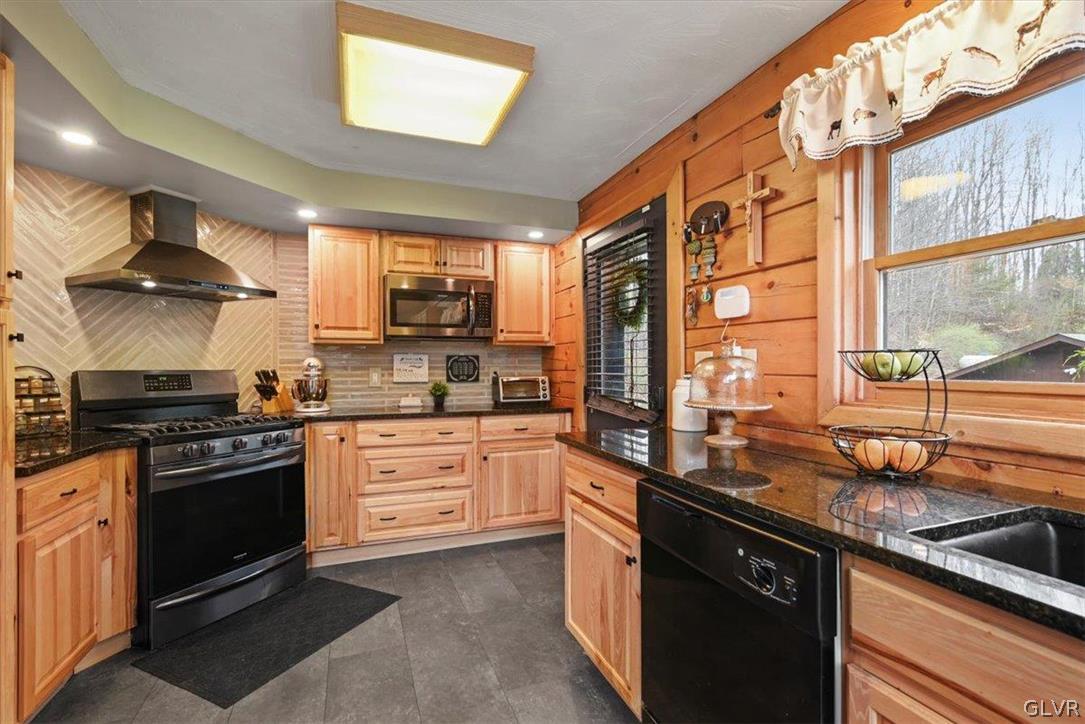 461 T Rte 318 Moscow, PA 18444 - Photo 14 of 50 a kitchen with stainless steel appliances granite countertop a sink a stove and a refrigerator