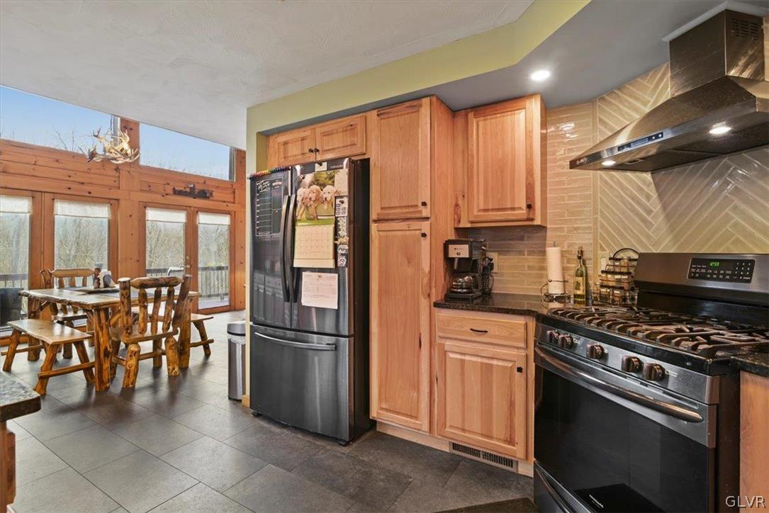 461 T Rte 318 Moscow, PA 18444 - Photo 17 of 50 a kitchen with stainless steel appliances granite countertop a stove refrigerator and a table