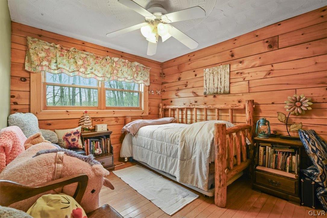 461 T Rte 318 Moscow, PA 18444 - Photo 19 of 50 a bed room with a bed and a chandelier