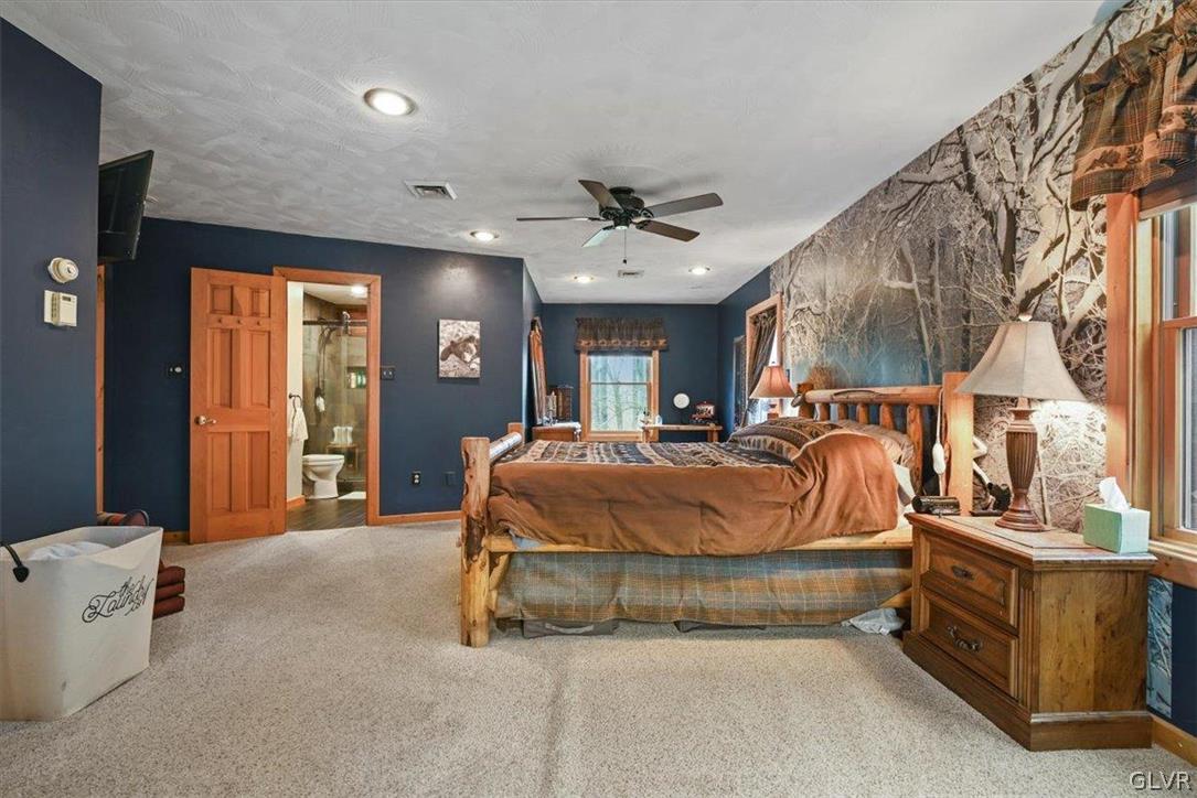 461 T Rte 318 Moscow, PA 18444 - Photo 24 of 50 a bed room with a bed and a chandelier