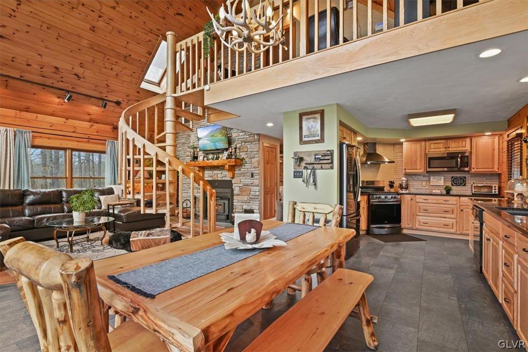461 T Rte 318 Moscow, PA 18444 - Photo 8 of 50 a living room filled with furniture hardwood floor and a kitchen view
