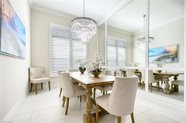 a living room with furniture a fireplace and a chandelier