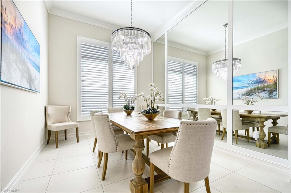 6159 Rodney Bay Lane Naples, FL 34113 - Photo 11 of 50 a view of a dining room with furniture wooden floor and chandelier