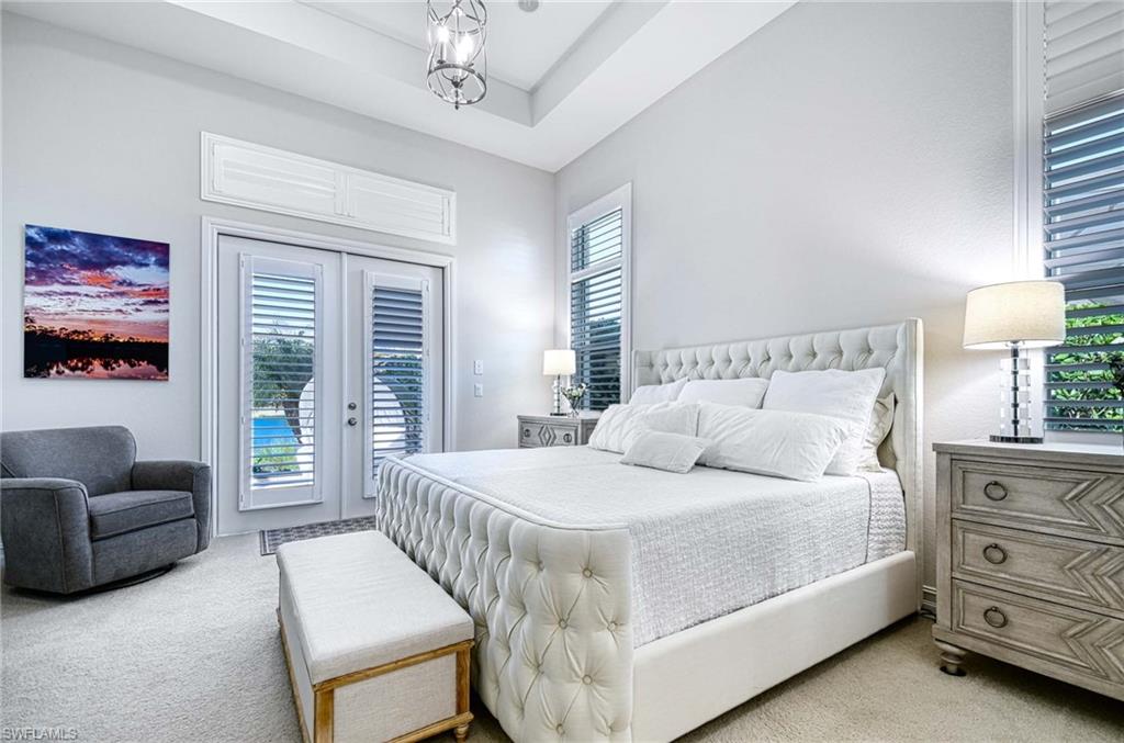 6159 Rodney Bay Lane Naples, FL 34113 - Photo 12 of 50 a bedroom with a bed and a couch