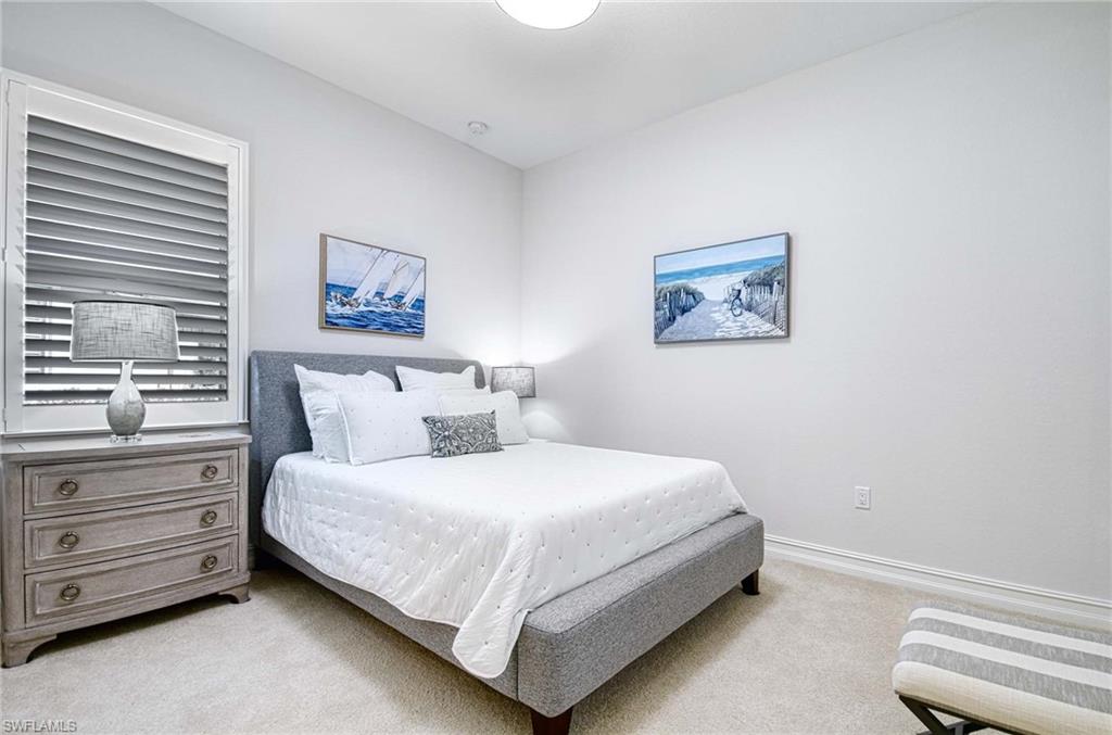 6159 Rodney Bay Lane Naples, FL 34113 - Photo 19 of 50 a bedroom with a bed and a window