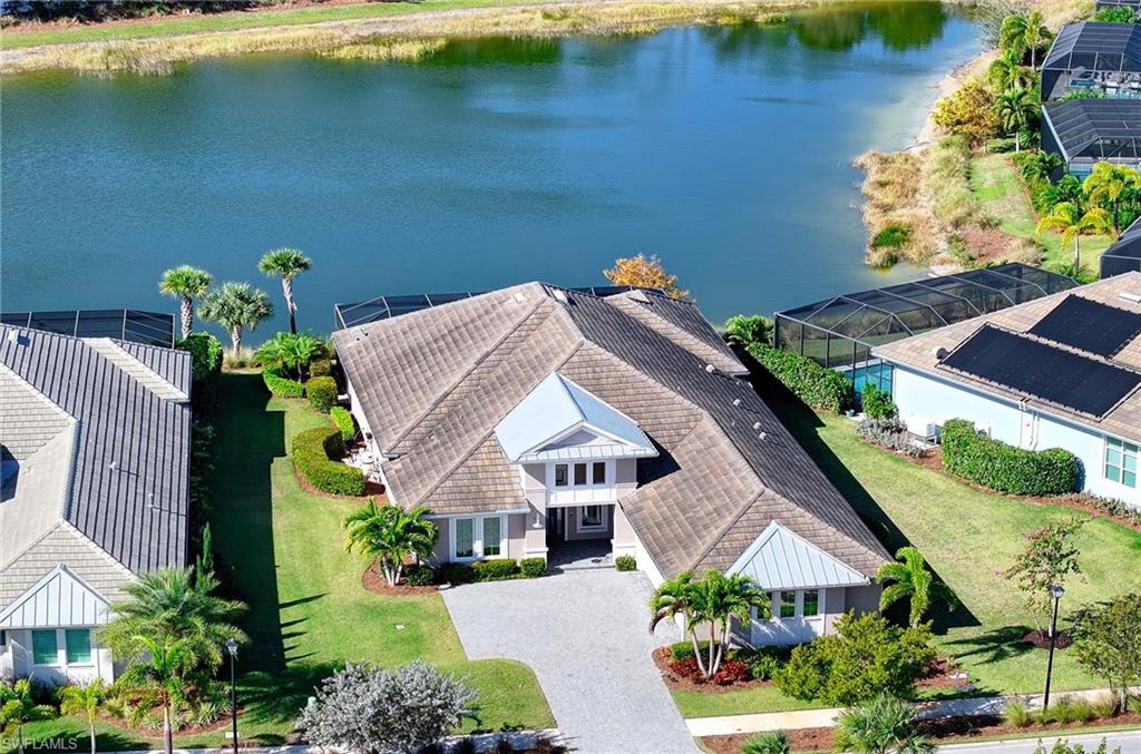 6159 Rodney Bay Lane Naples, FL 34113 - Photo 2 of 50 an aerial view of a house with a garden and lake view