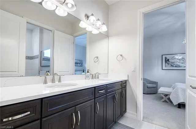 a spacious bathroom with a granite countertop sink a toilet and a mirror
