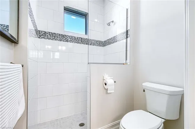a white toilet sitting next to a bathroom sink