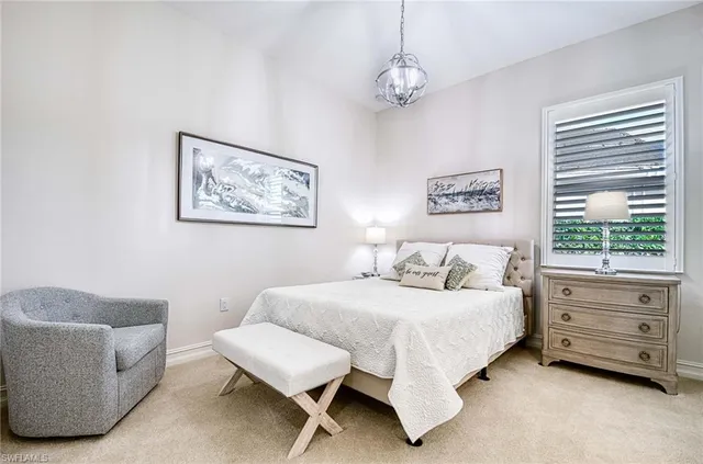 a bedroom with a bed a couch and a window