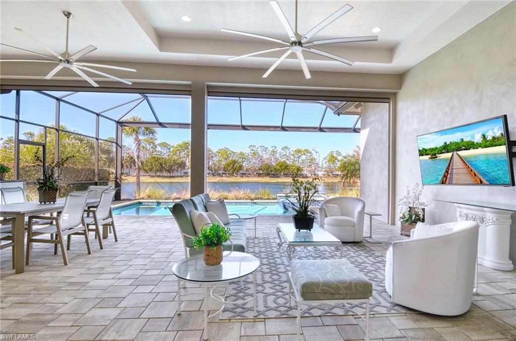 6159 Rodney Bay Lane Naples, FL 34113 - Photo 24 of 50 a living room with couches a coffee table and a potted plant