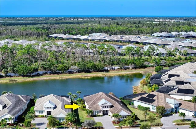an aerial view of ocean and residential houses with outdoor space and lake view