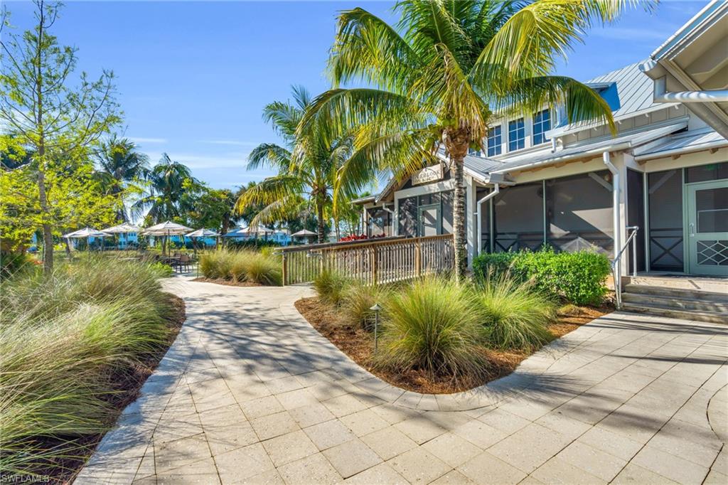 6159 Rodney Bay Lane Naples, FL 34113 - Photo 37 of 50 a front view of a house with swimming pool and glass windows