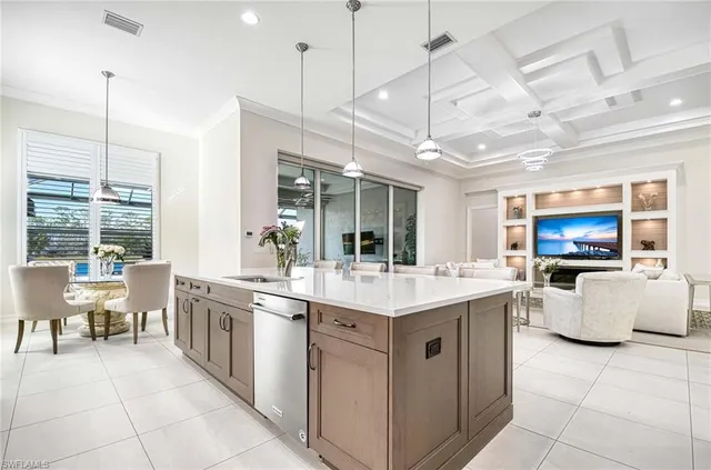 a view of kitchen with stainless steel appliances granite countertop center island a stove a sink a dining table and chairs