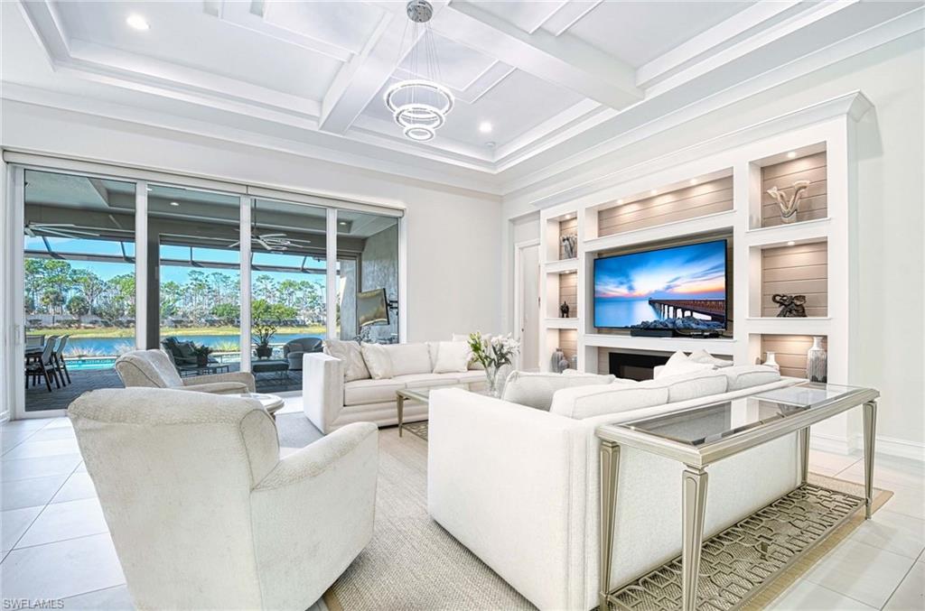 6159 Rodney Bay Lane Naples, FL 34113 - Photo 8 of 50 a living room with furniture and a flat screen tv