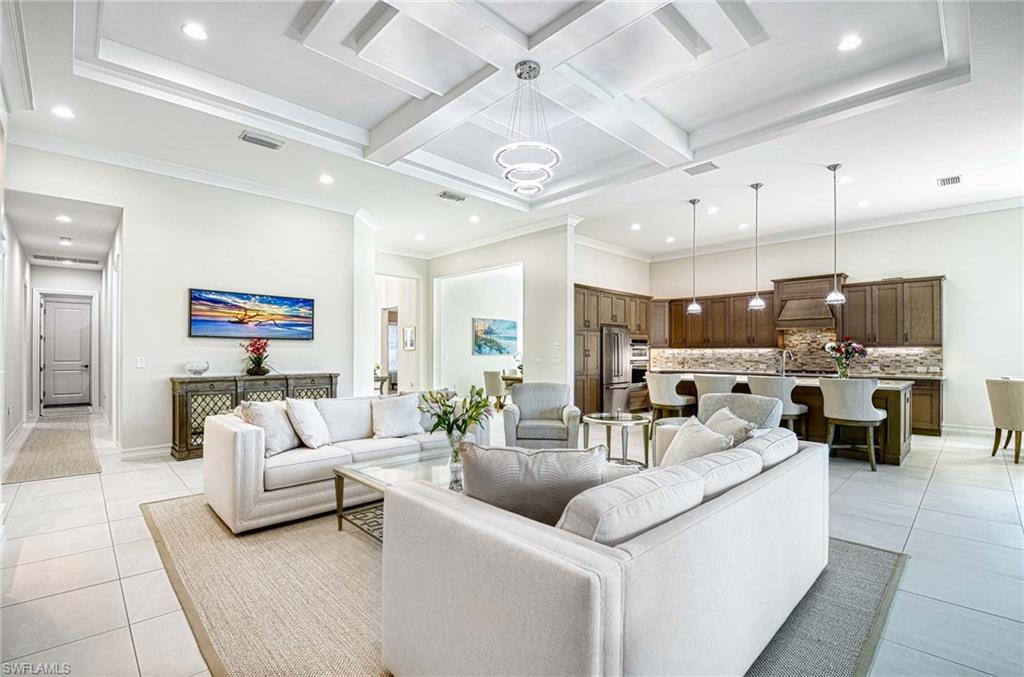 6159 Rodney Bay Lane Naples, FL 34113 - Photo 50 of 50 a living room with furniture kitchen view and a chandelier