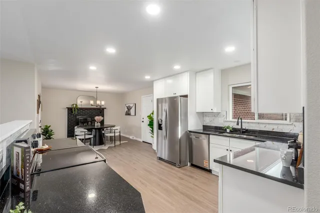 a kitchen with stainless steel appliances a refrigerator and a stove top oven