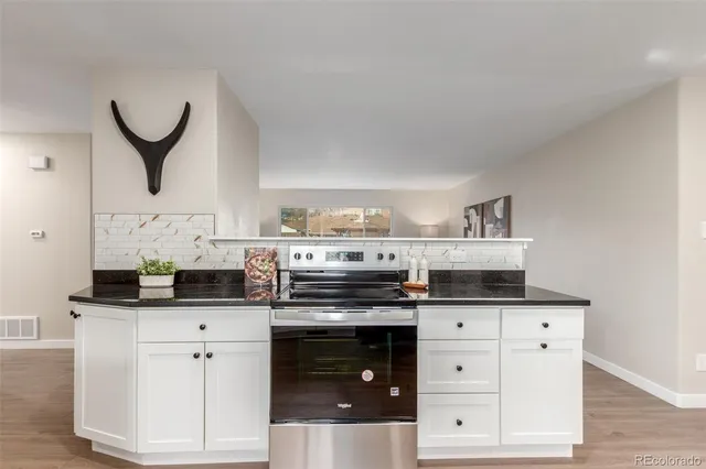 a kitchen with granite countertop a sink and a window