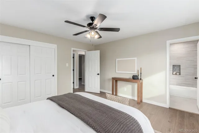 a bedroom with a bed and a ceiling fan
