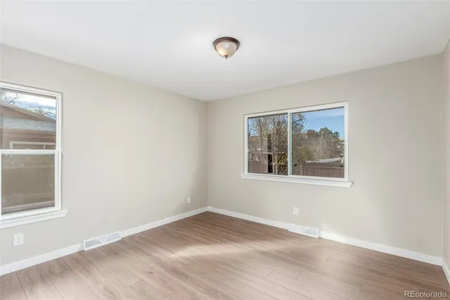 a bathroom with a double vanity sink toilet and a mirror