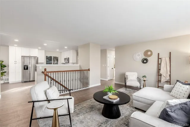a dining room with furniture wooden floor a rug and a chandelier