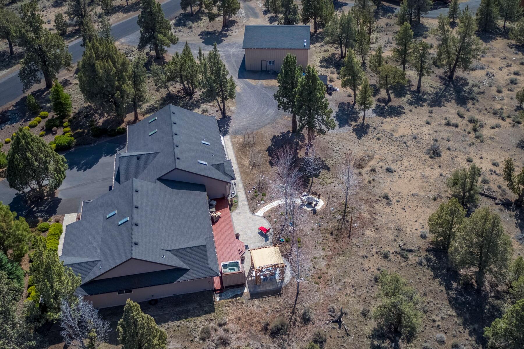 64585 Joe Neil Road Bend, OR 97701 - Photo 26 of 35 an aerial view of a house with a yard and tree s
