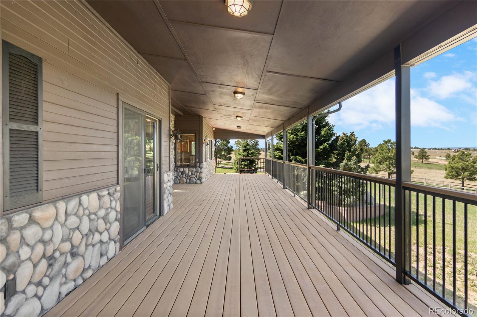 74 Rocky Cliff Road Elizabeth, CO 80107 - Photo 47 of 50 a view of a balcony with wooden floor
