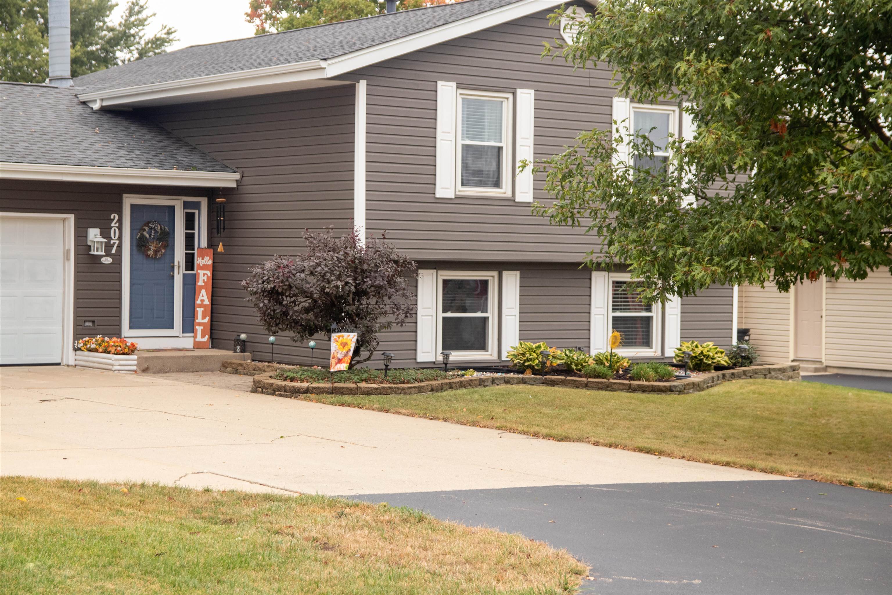 207 Westfield Road Winnebago, IL 61088 - Photo 1 of 27 a front view of a house with a yard