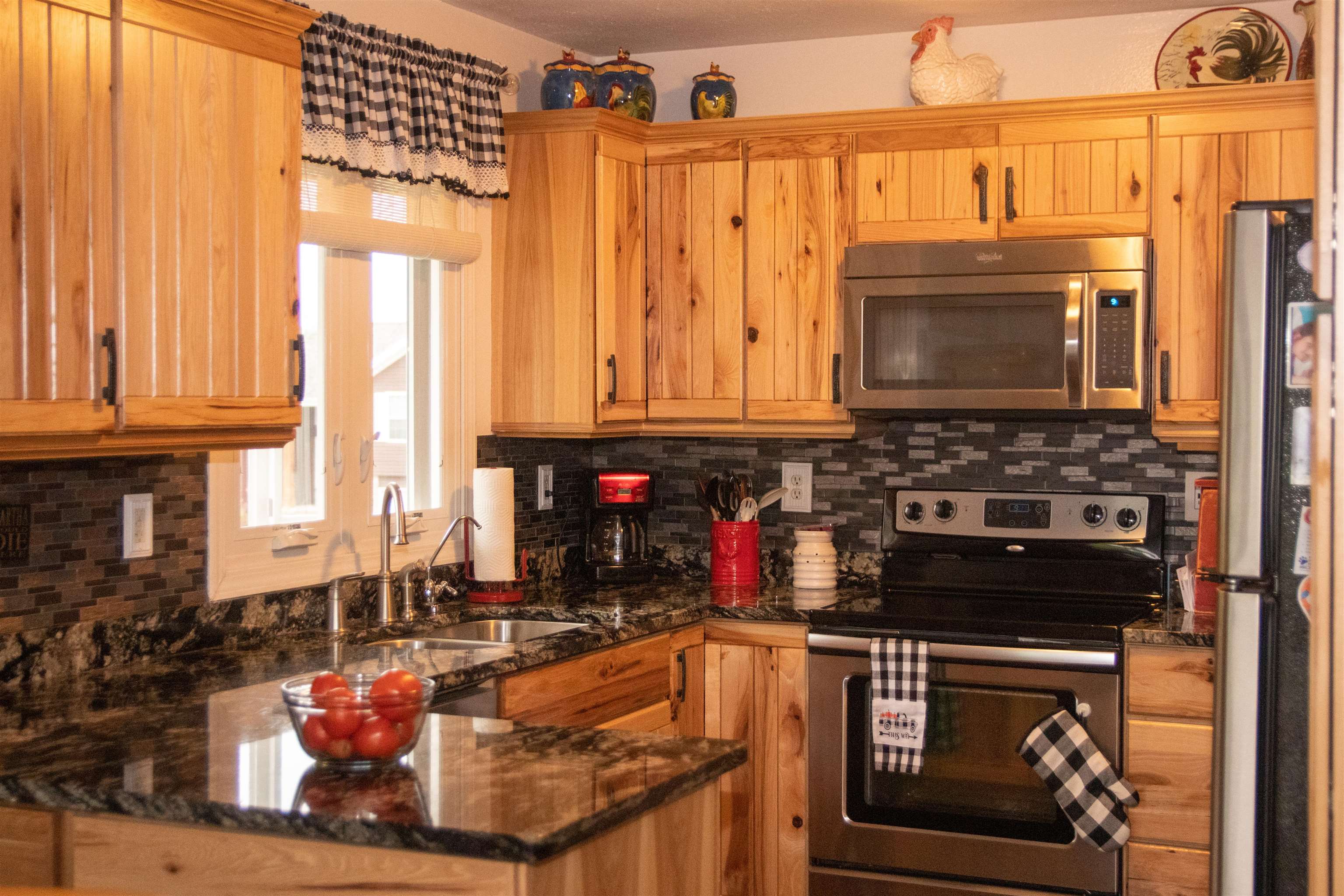 207 Westfield Road Winnebago, IL 61088 - Photo 11 of 27 a kitchen with a stove a sink and a microwave