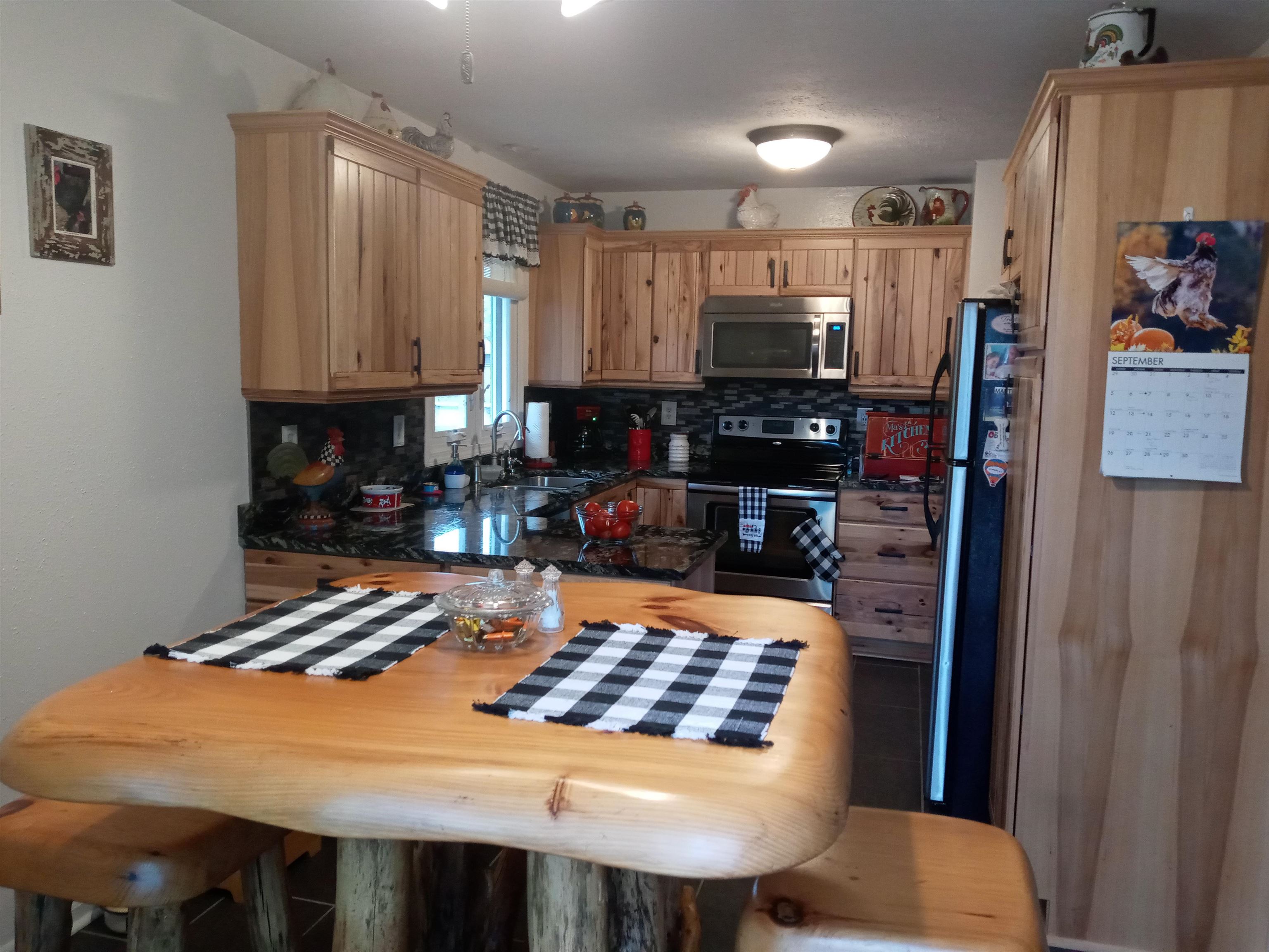 207 Westfield Road Winnebago, IL 61088 - Photo 12 of 27 a kitchen with a table chairs and a refrigerator