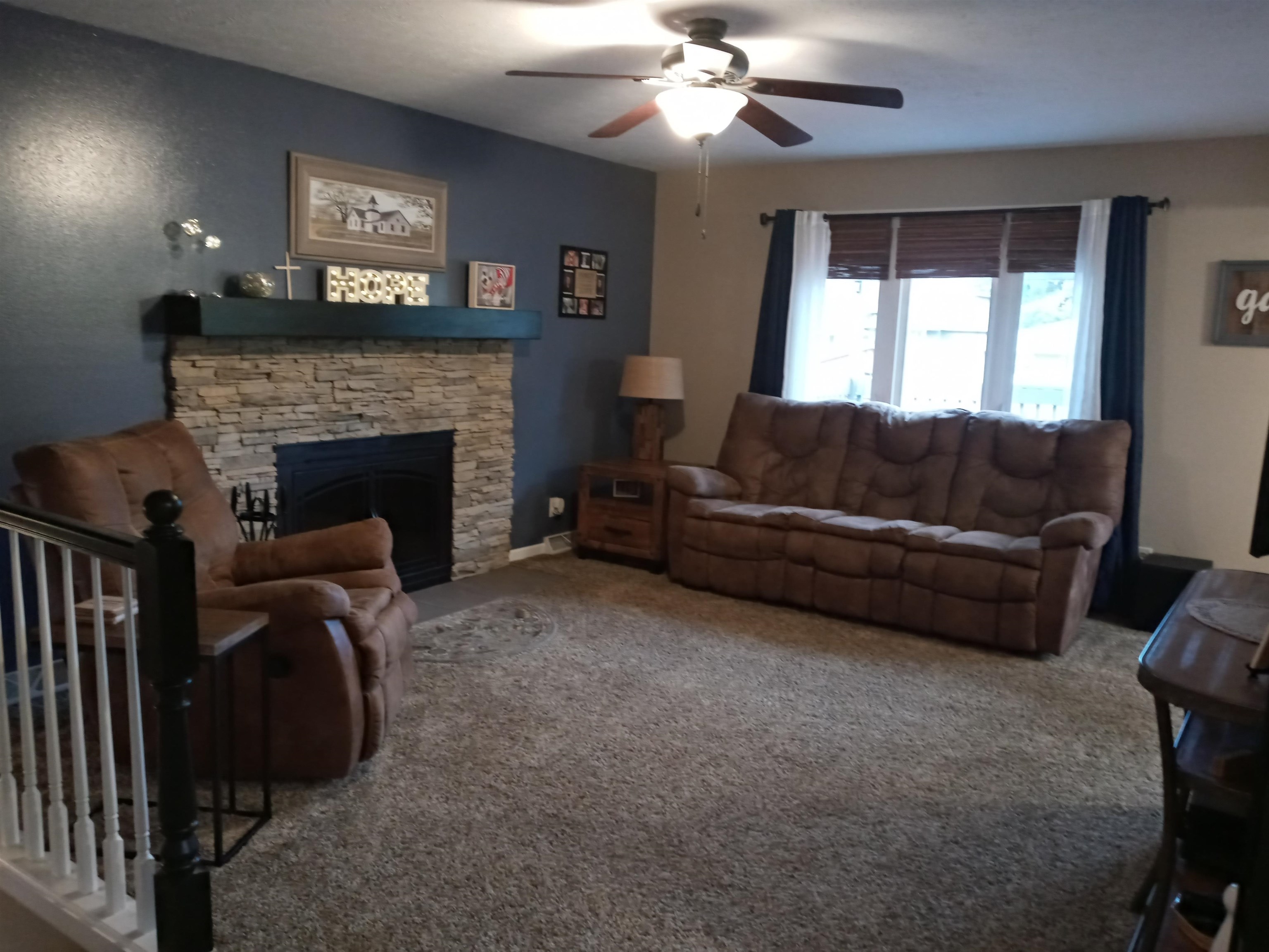 207 Westfield Road Winnebago, IL 61088 - Photo 15 of 27 a living room with furniture and a fireplace