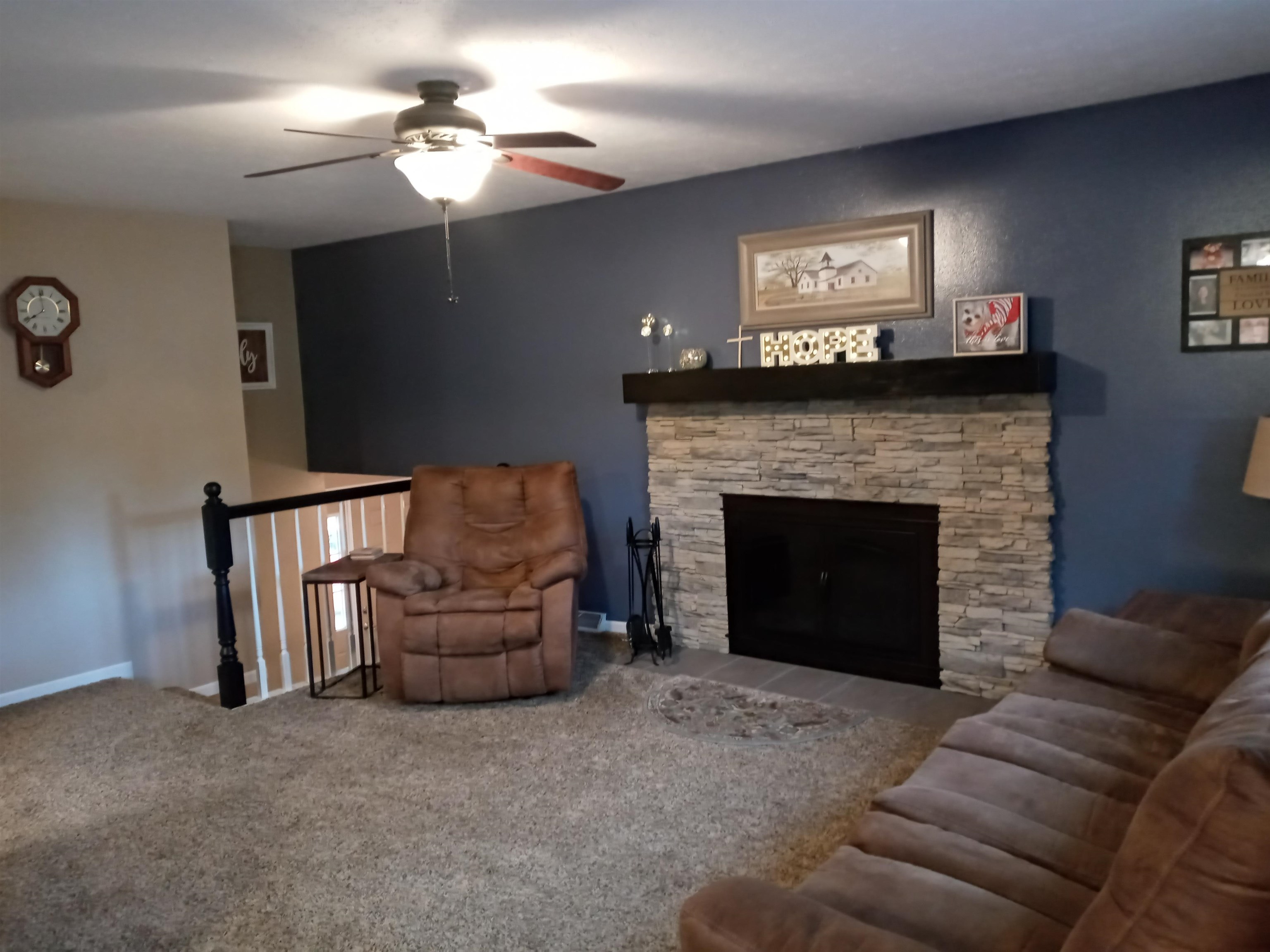 207 Westfield Road Winnebago, IL 61088 - Photo 16 of 27 a living room with furniture and a fireplace