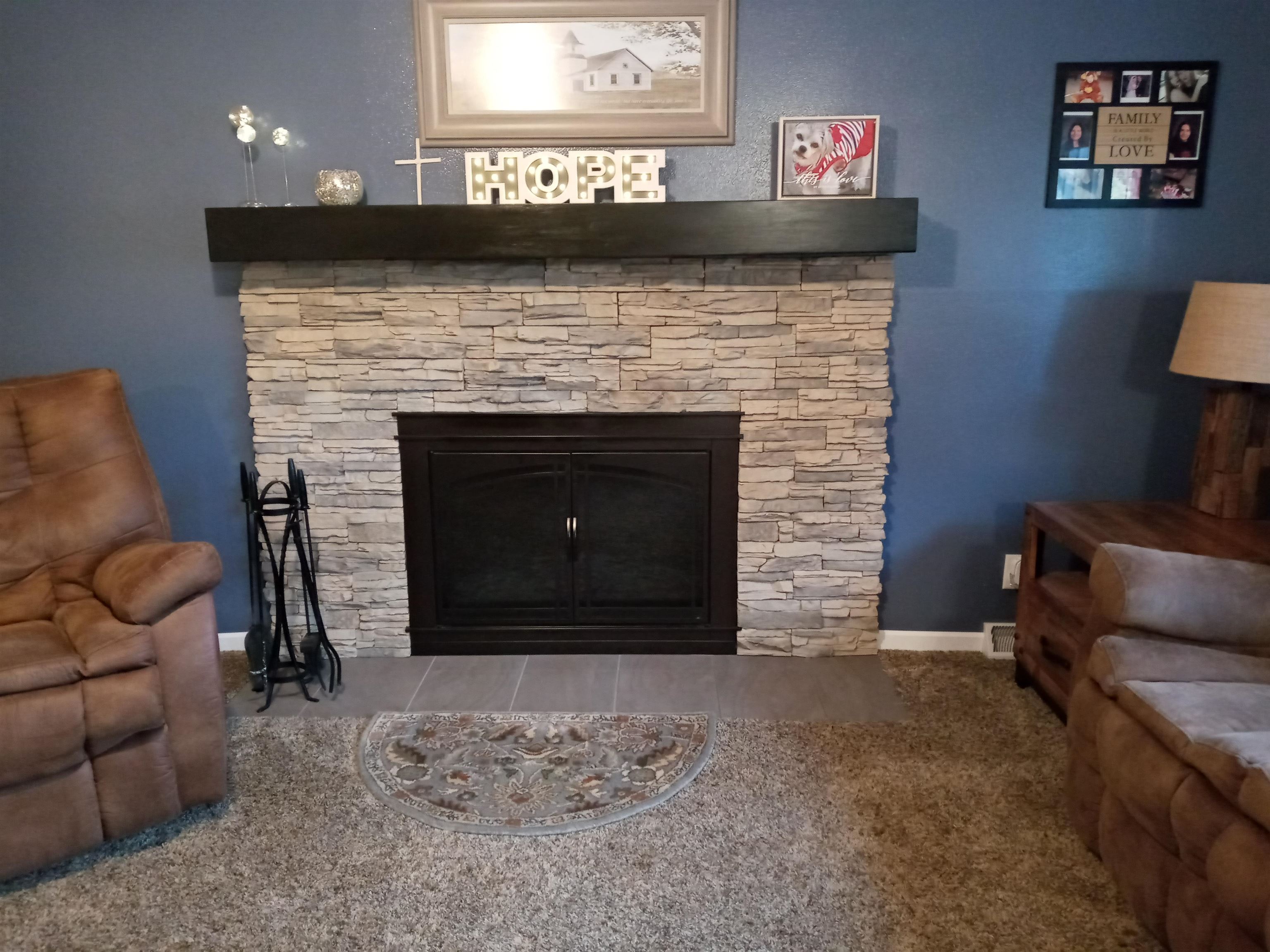 207 Westfield Road Winnebago, IL 61088 - Photo 17 of 27 a living room with furniture and a fireplace