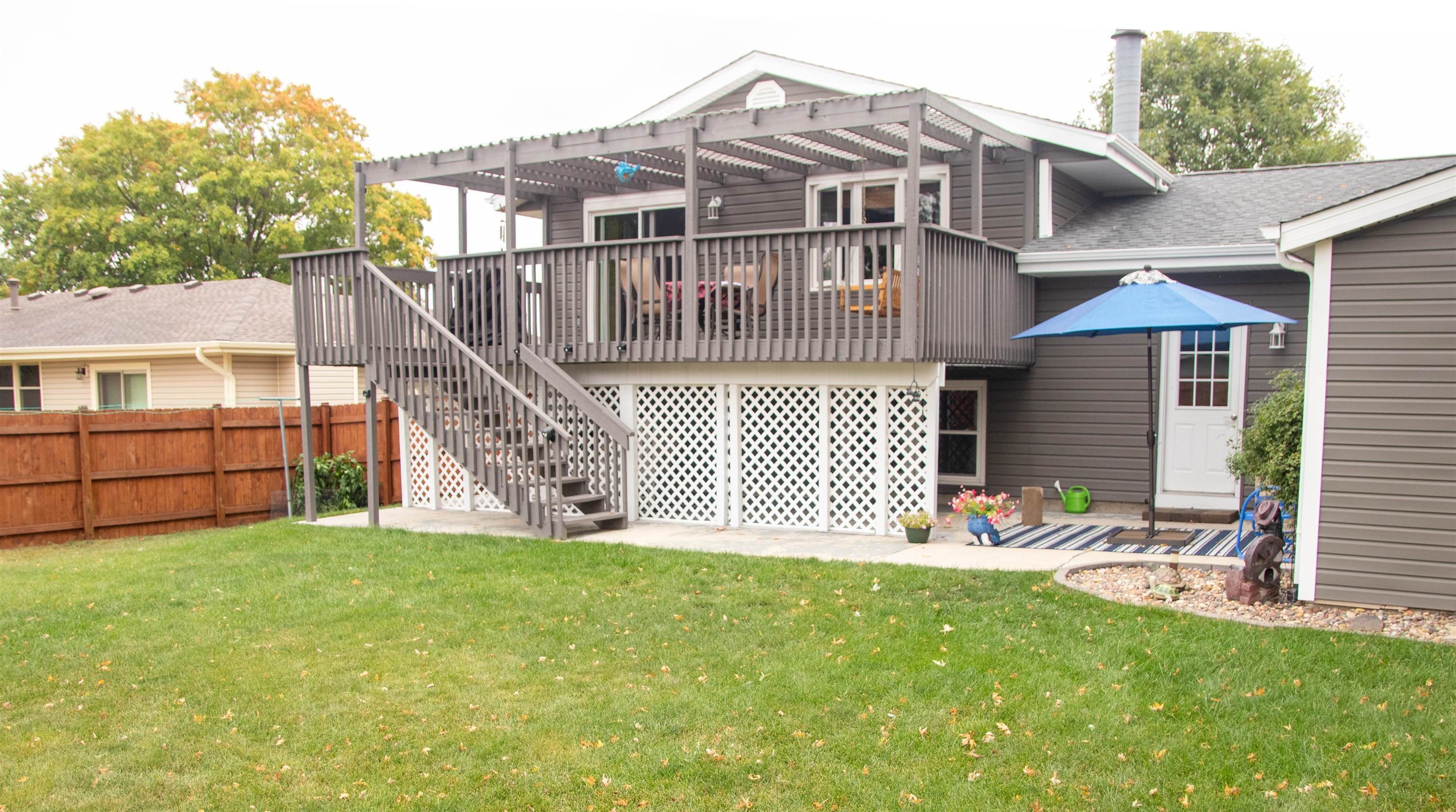 207 Westfield Road Winnebago, IL 61088 - Photo 4 of 27 a front view of a house with a yard with potted plants and a large tree