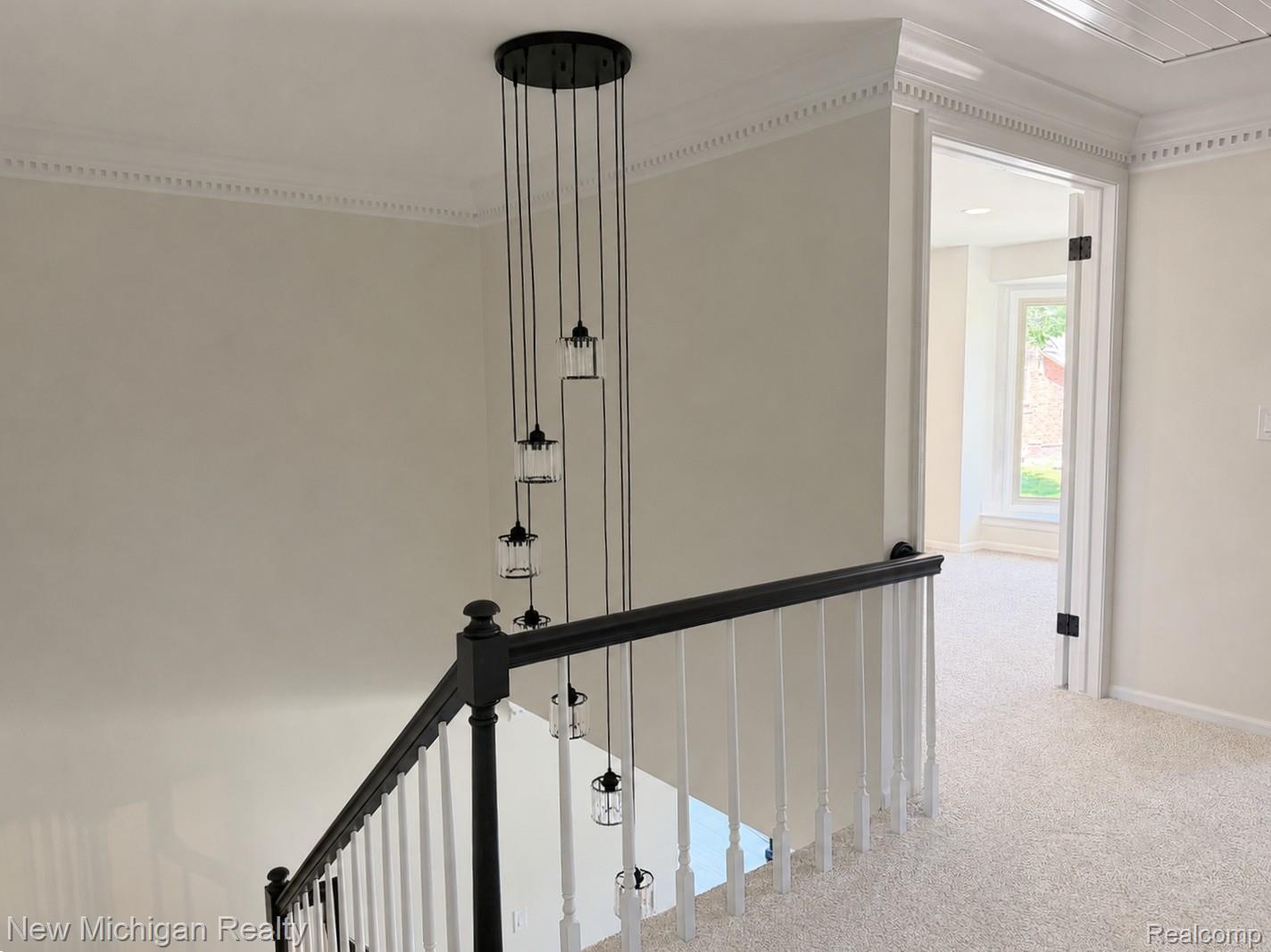 650 Deerfield Court Rochester, MI 48309 - Photo 19 of 37 Central staircase with extensive crown molding and 2-story Chandlier