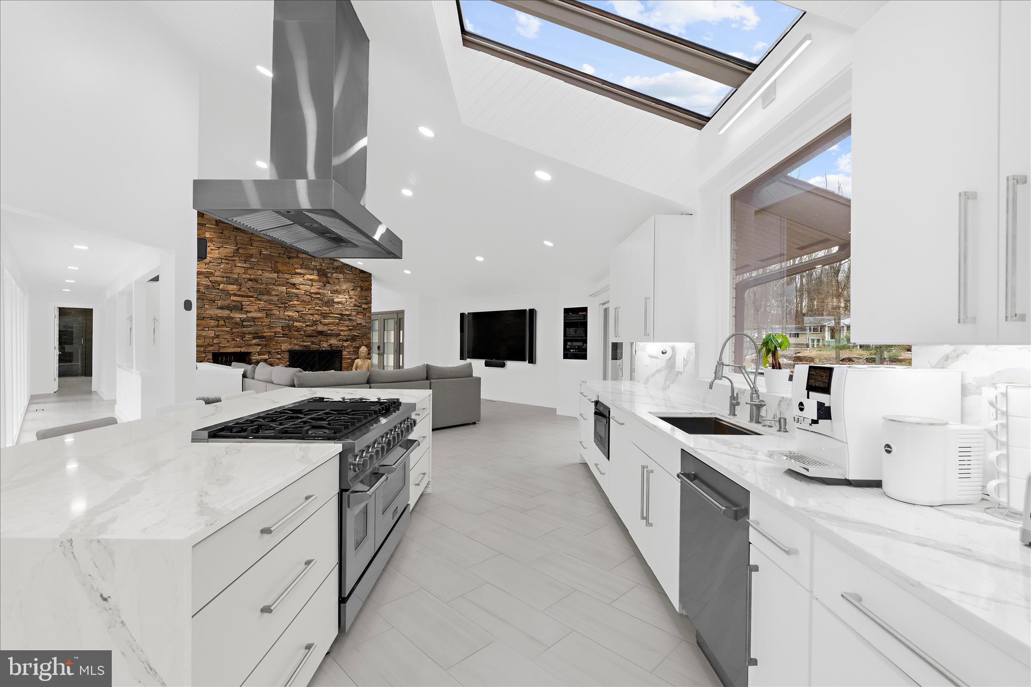 2308 Caves Road Owings Mills, MD 21117 - Photo 13 of 70 a large white kitchen with stainless steel appliances kitchen island granite countertop a large counter top and a stove