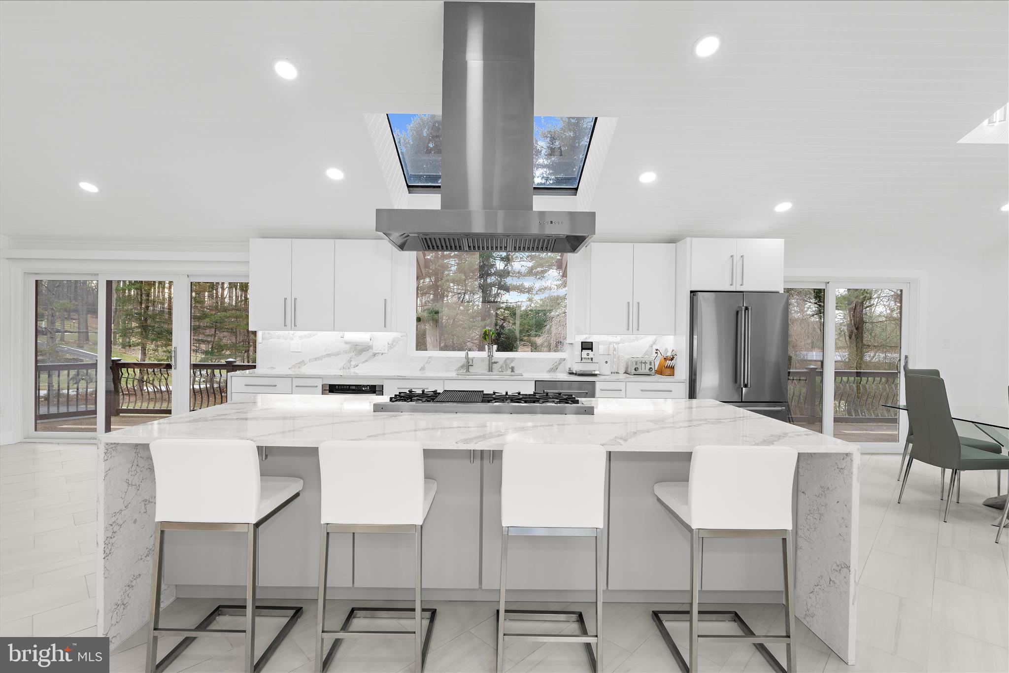 2308 Caves Road Owings Mills, MD 21117 - Photo 15 of 70 a kitchen with stainless steel appliances kitchen island granite countertop a stove a table and chairs in it