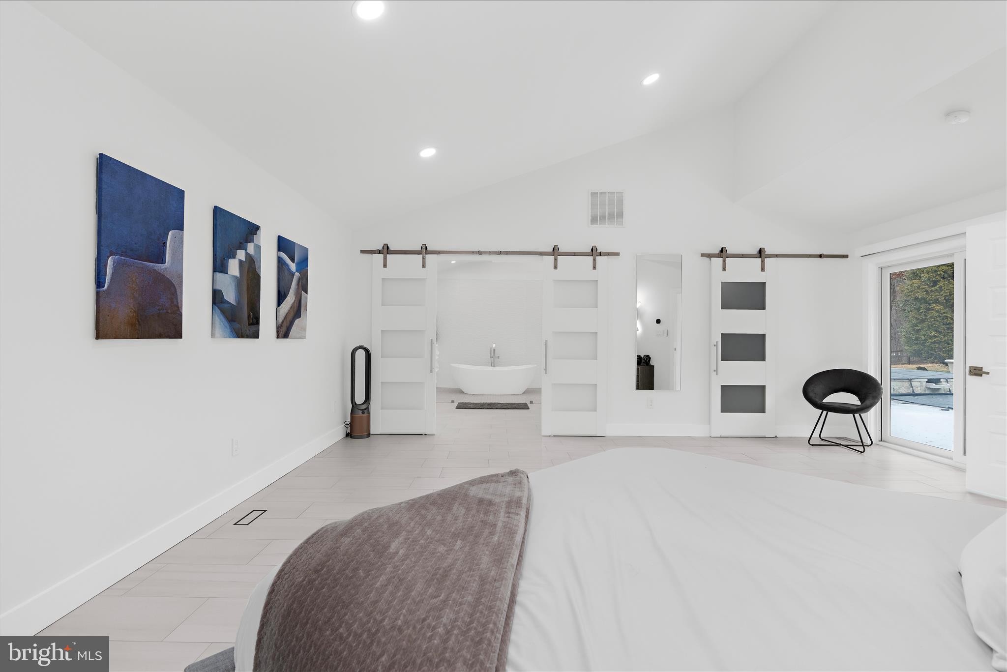 2308 Caves Road Owings Mills, MD 21117 - Photo 19 of 70 a spacious bedroom with a bed and a mirror