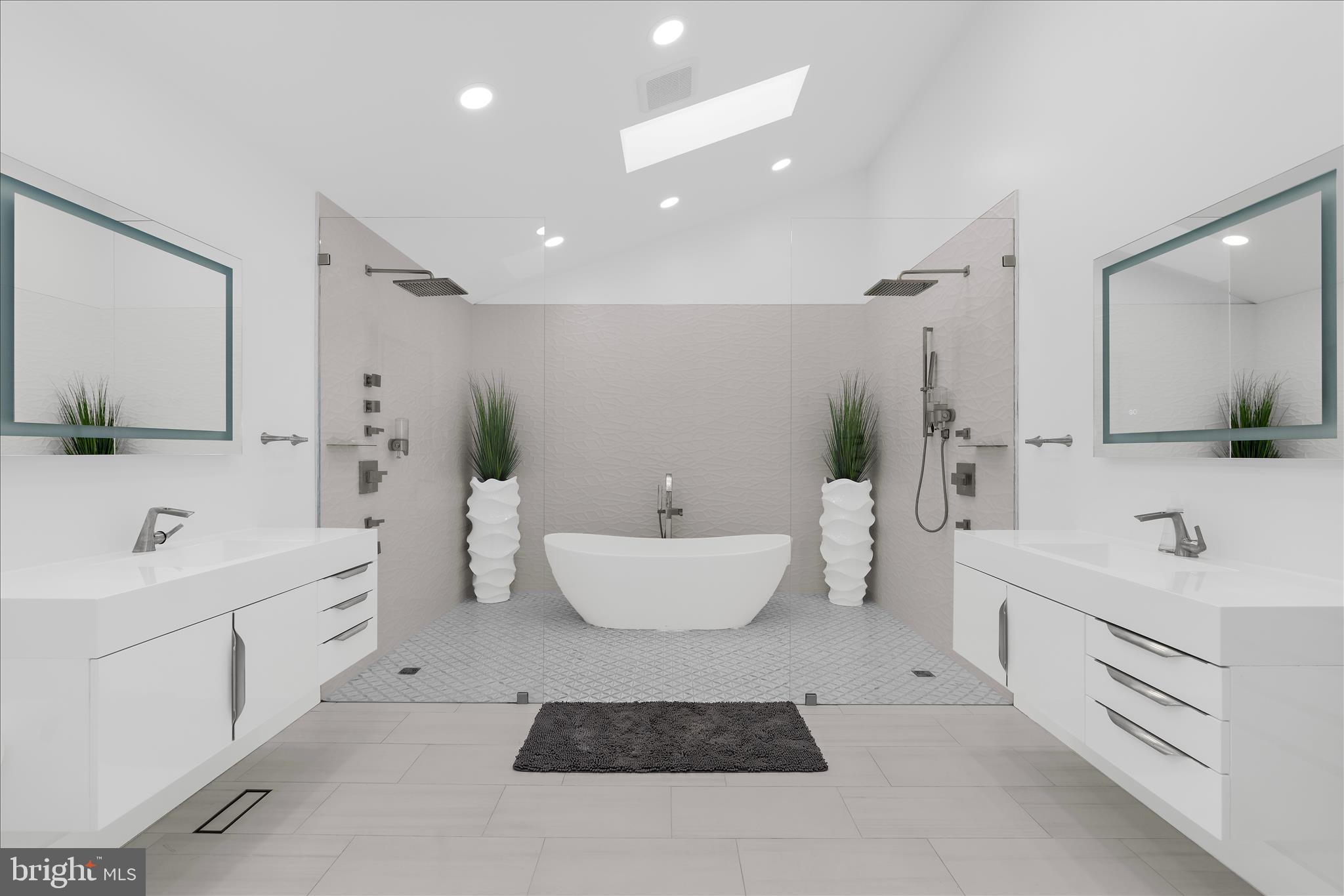 2308 Caves Road Owings Mills, MD 21117 - Photo 20 of 70 a bathroom with a double vanity sink a toilet a mirror and bathtub