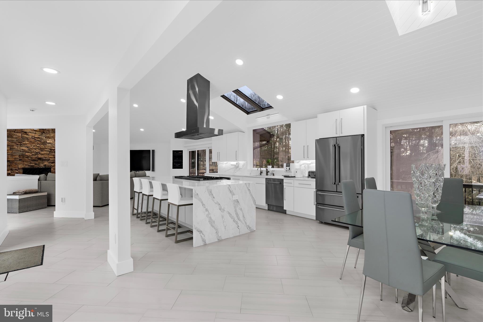 2308 Caves Road Owings Mills, MD 21117 - Photo 24 of 70 a kitchen with white cabinets and stainless steel appliances