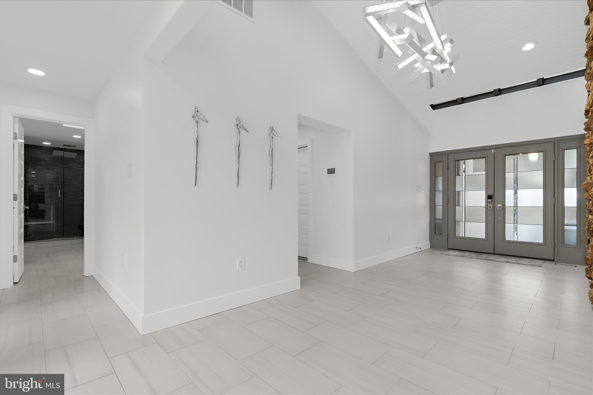 2308 Caves Road Owings Mills, MD 21117 - Photo 25 of 70 wooden floor in an empty room with a chandelier