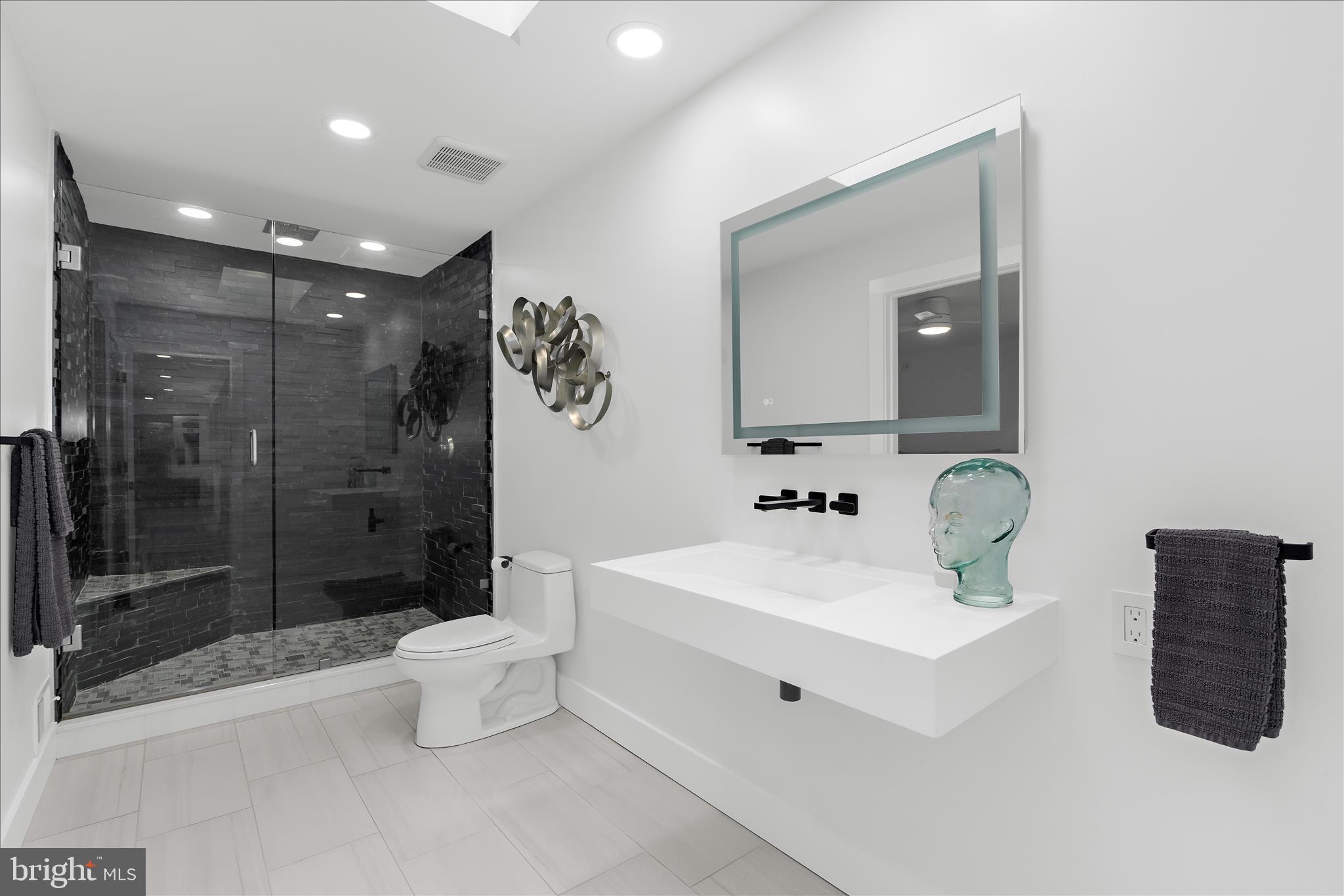 2308 Caves Road Owings Mills, MD 21117 - Photo 26 of 70 a bathroom with a sink a toilet and shower