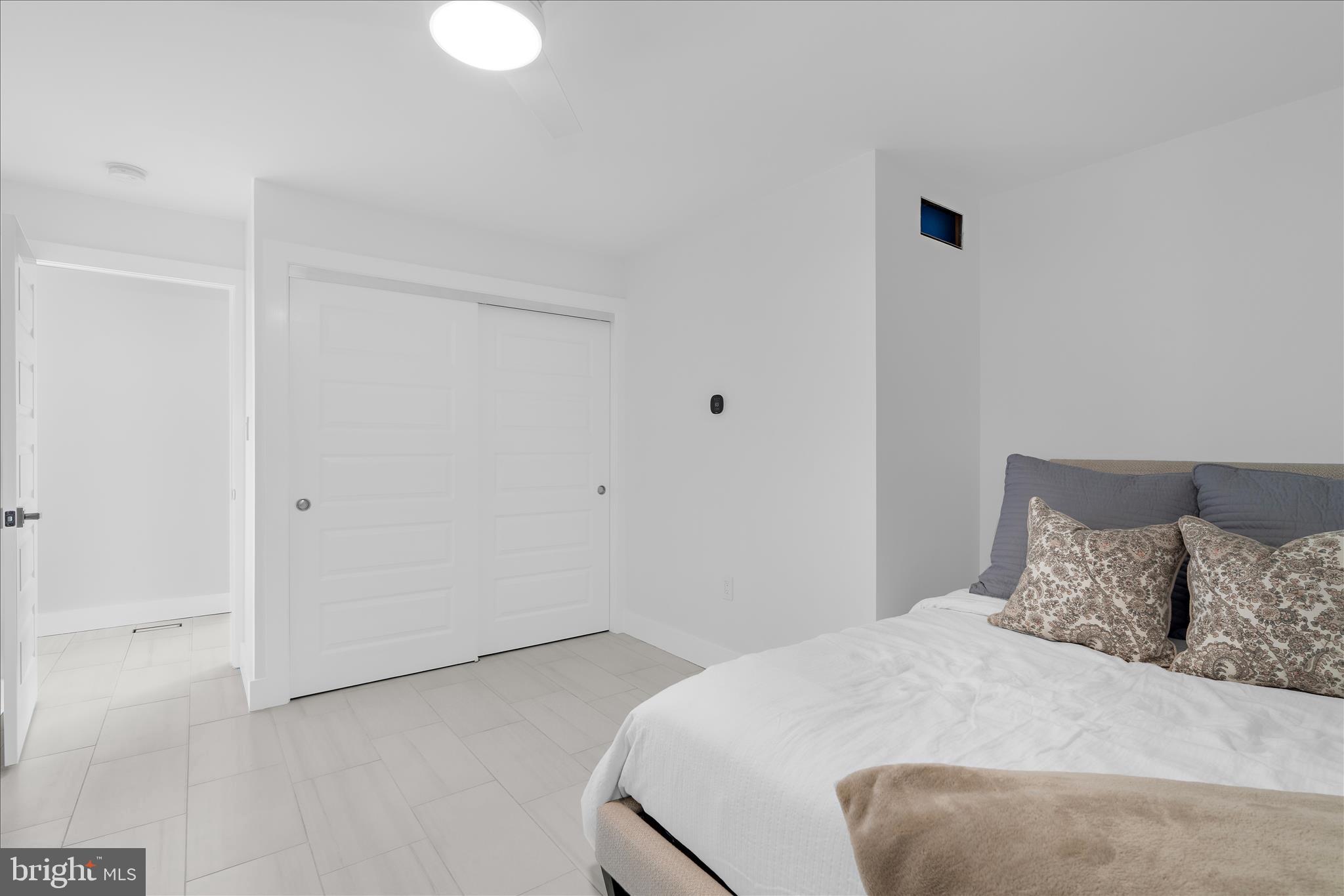 2308 Caves Road Owings Mills, MD 21117 - Photo 27 of 70 a bedroom with a bed and a lamp