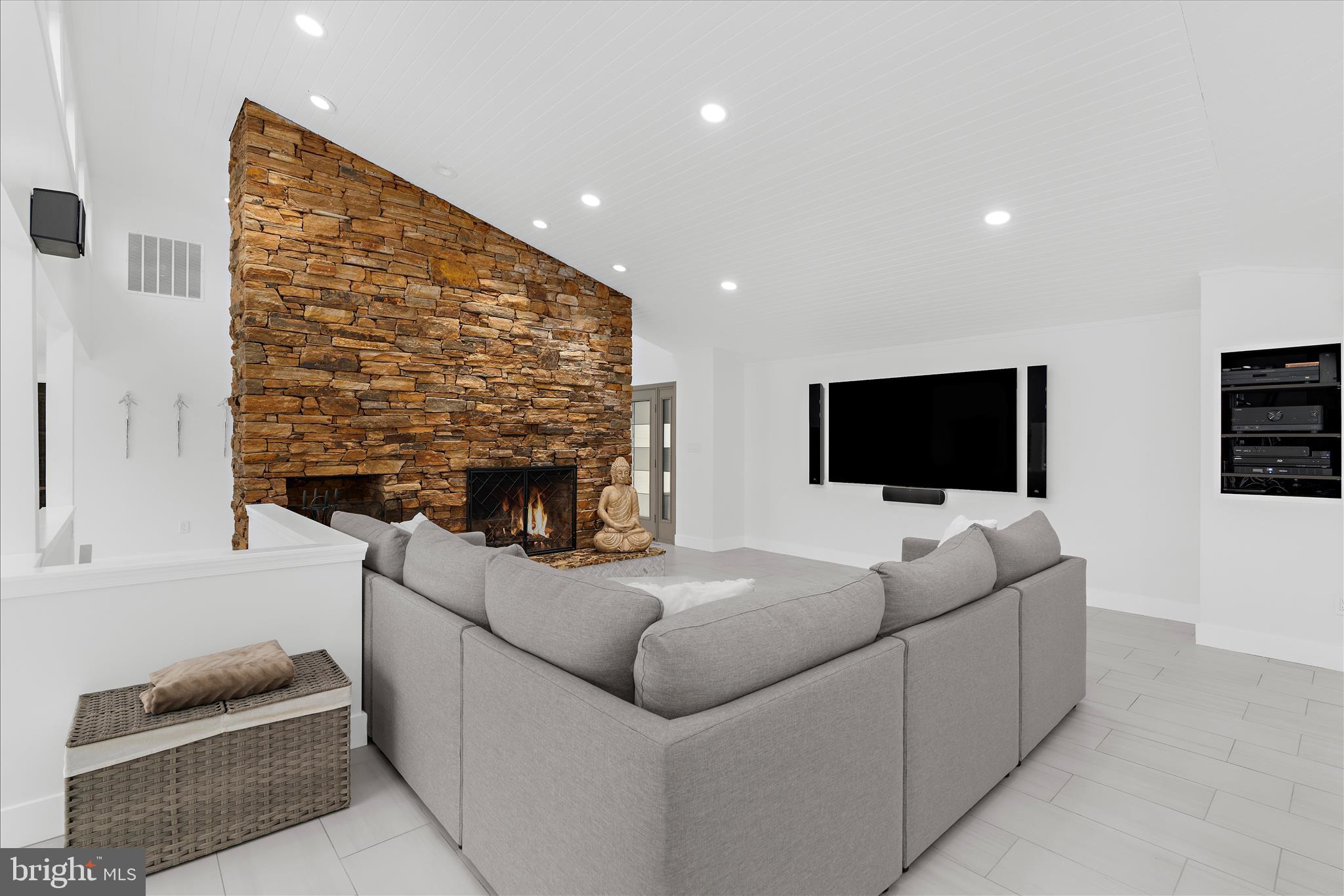 2308 Caves Road Owings Mills, MD 21117 - Photo 8 of 70 a living room with furniture a flat screen tv and a fireplace