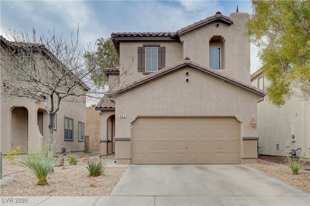 645 Monument Point Street Henderson, NV 89002 - Photo 1 of 54 Mediterranean / spanish-style house featuring a tile roof, stucco siding, a garage, and concrete driveway