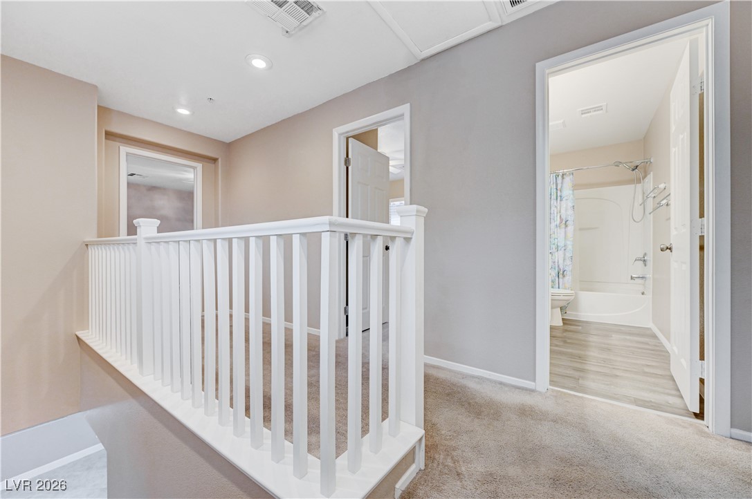 645 Monument Point Street Henderson, NV 89002 - Photo 24 of 54 Hallway with light colored carpet, an upstairs landing, and recessed lighting