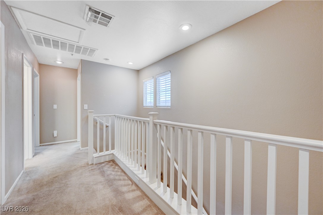645 Monument Point Street Henderson, NV 89002 - Photo 25 of 54 Corridor with an upstairs landing, carpet flooring, and recessed lighting